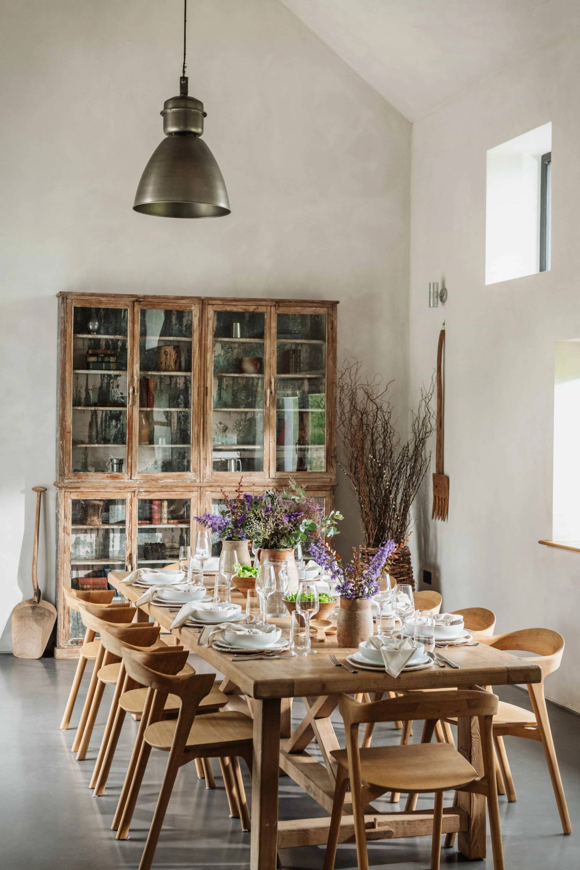 Formal country dining room film location in Castleblayney County Monaghan Ireland from Love Locations, with a long dining table, vintage wooden dressers, and dried flower arrangements.