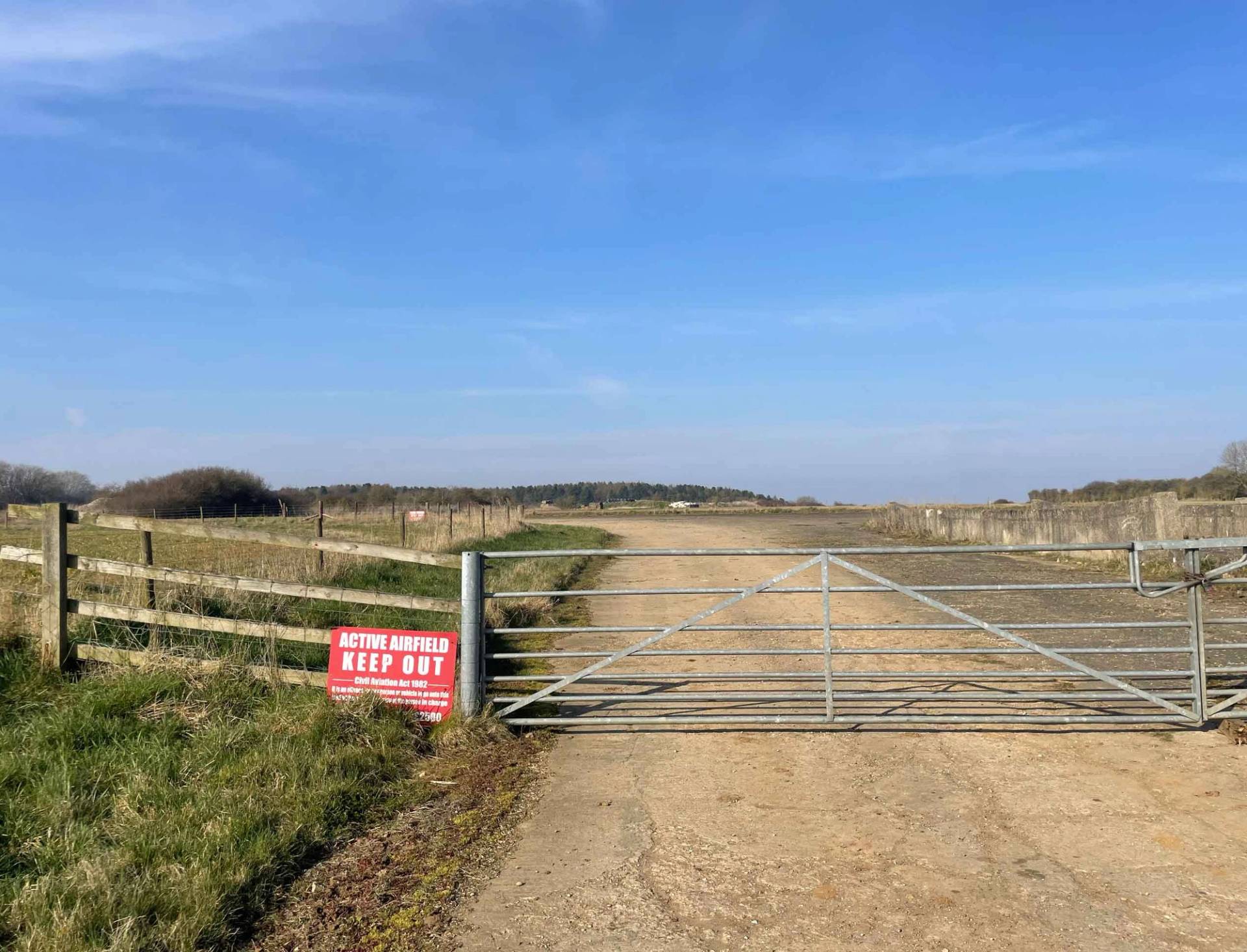 Rural security gate marking the boundary of a historic airfield and farm property in Corby, NN17, Love Locations.