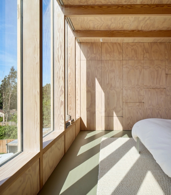 Bedroom nook detail with natural plywood panelling and deep timber window seat ledge, Love Locations E17.