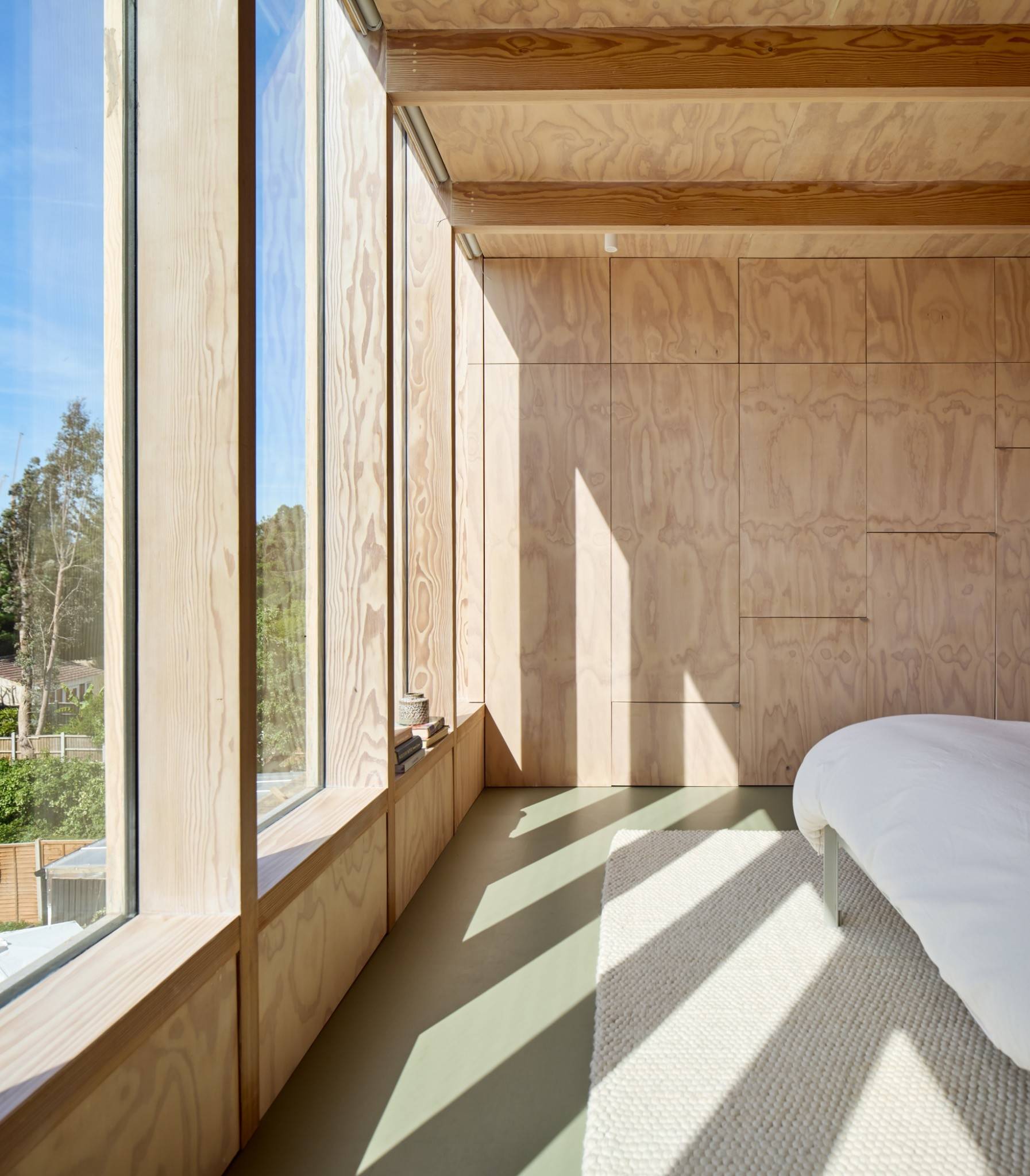 Bedroom nook detail with natural plywood panelling and deep timber window seat ledge, Love Locations E17.