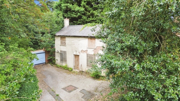 High-angle view of a derelict cottage set back on an overgrown plot, a secluded and spooky filming location via Love Locations.
