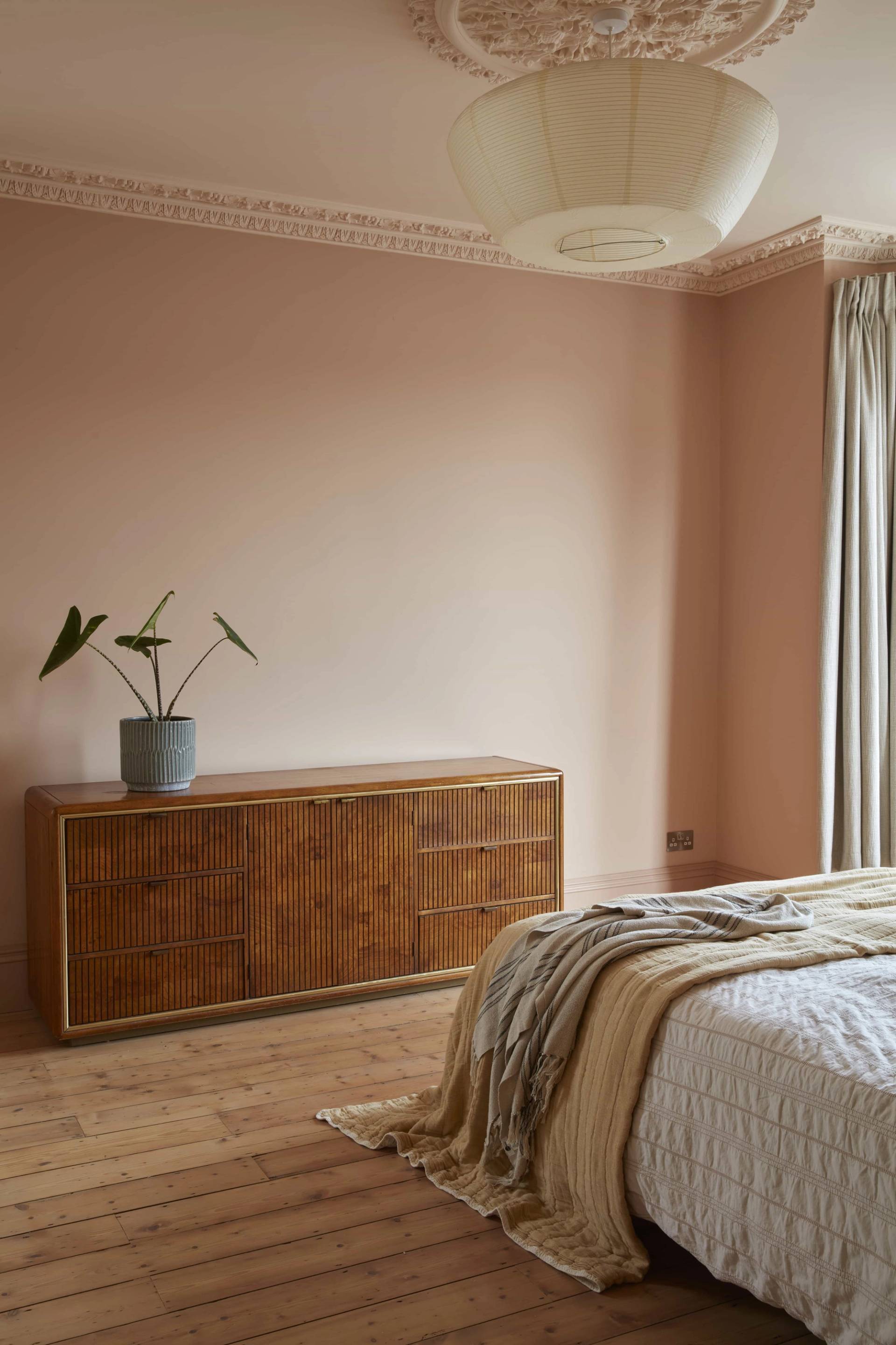 Elegantly styled bedroom corner with a wooden chest of drawers set against plaster walls, Love Locations TN34.