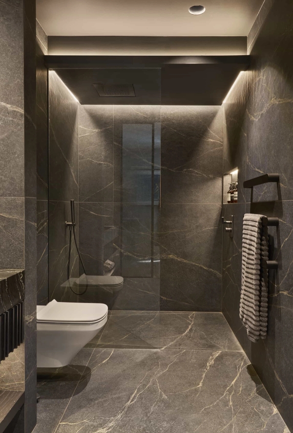 Moody dark slate wet room bathroom with integrated LED strip lighting, an atmospheric filming location by Love Locations.