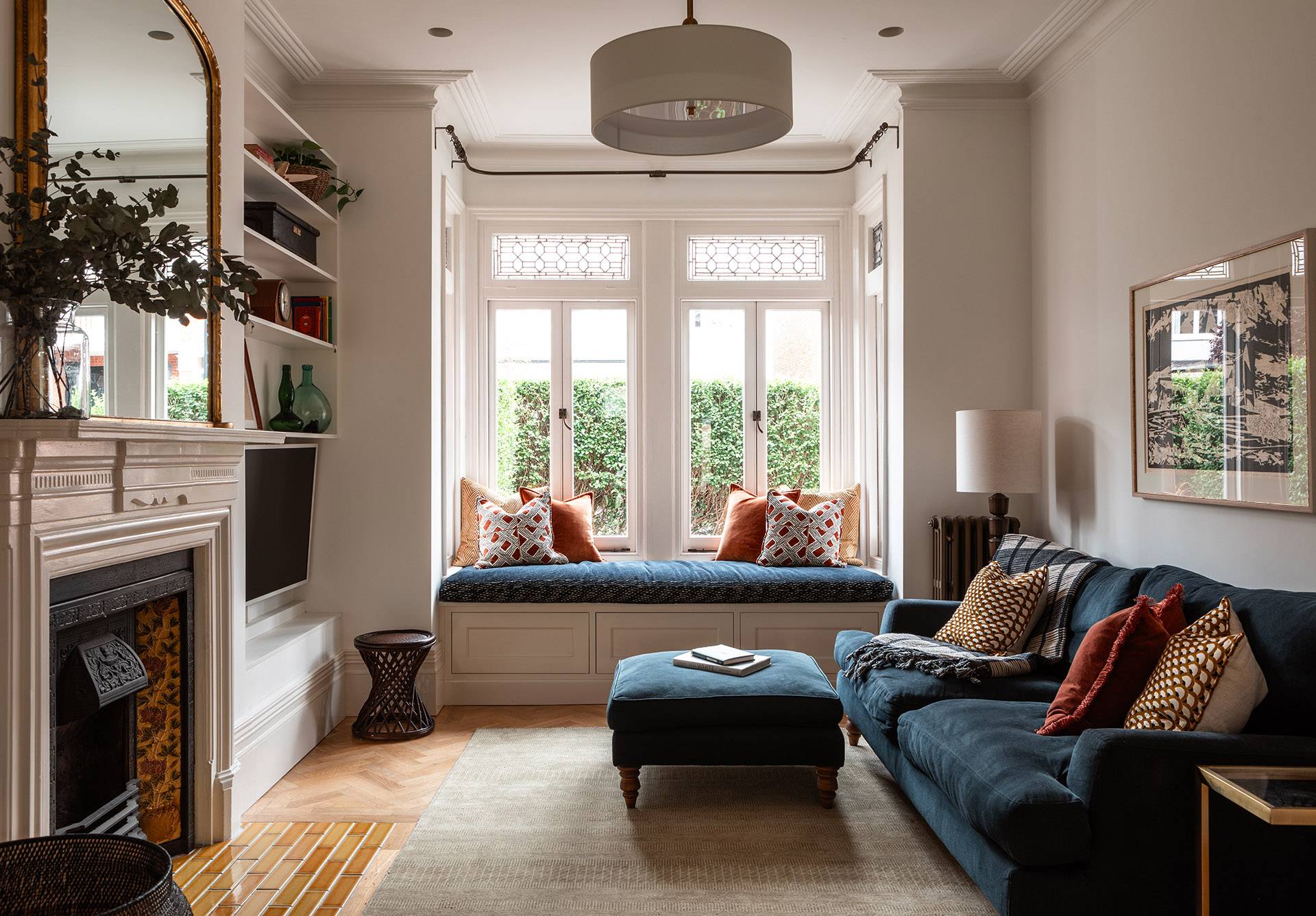 Bespoke upholstered window seat arrangement framed by built-in bookshelves and soft natural light, perfect for reading campaign shoots, Love Locations.