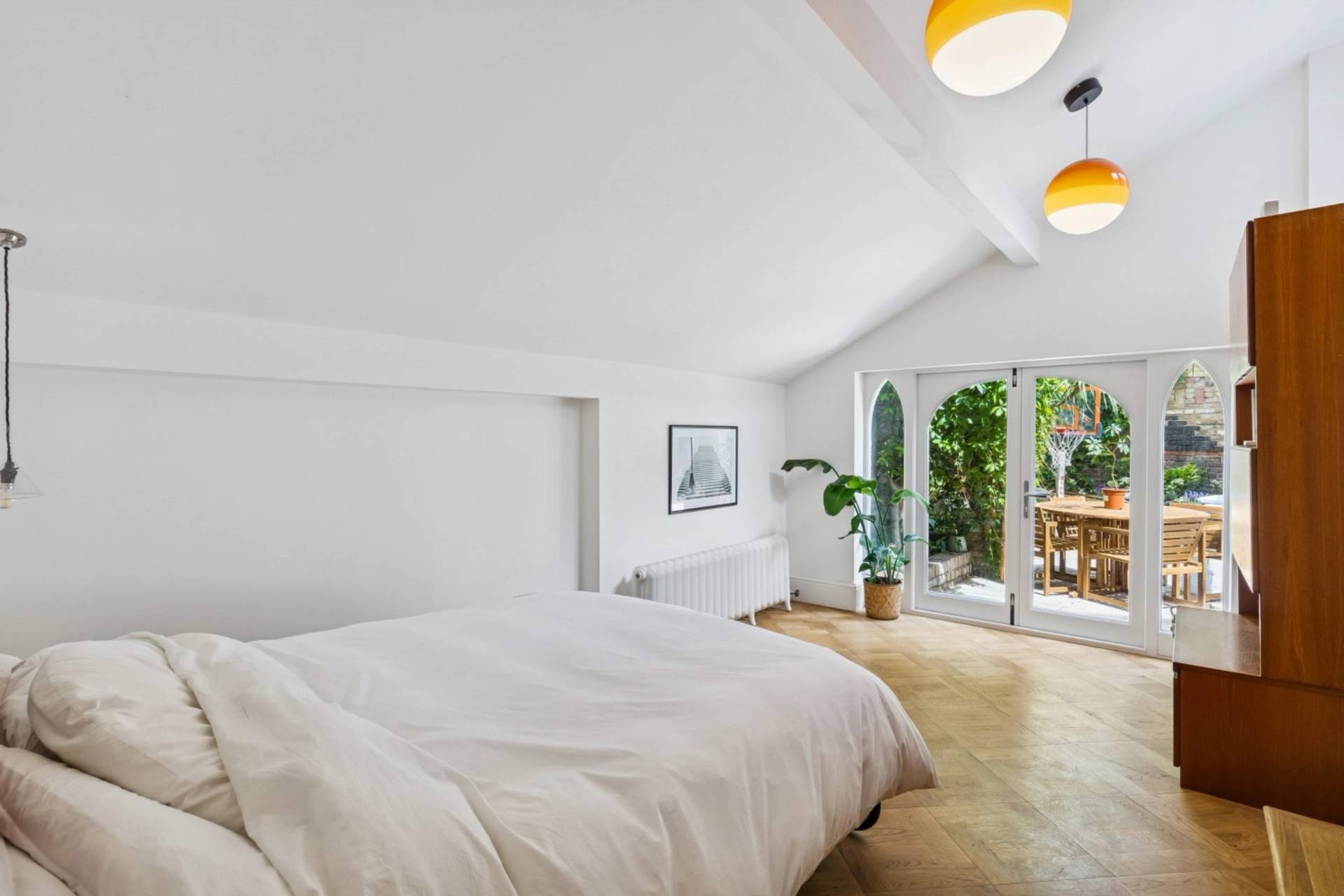 Bright loft bedroom shoot space with pitched ceiling and garden doors in Hampstead NW3 by Love Locations.