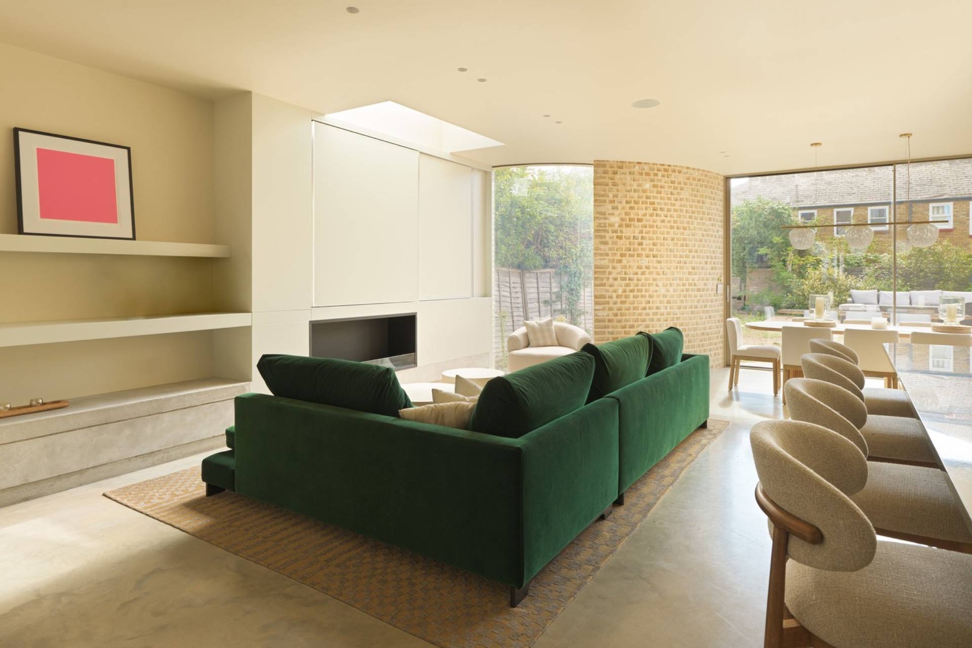 Contemporary living room filming location in Clapham South SW11 with green velvet seating, polished concrete floor, and skylight lighting from Love Locations.