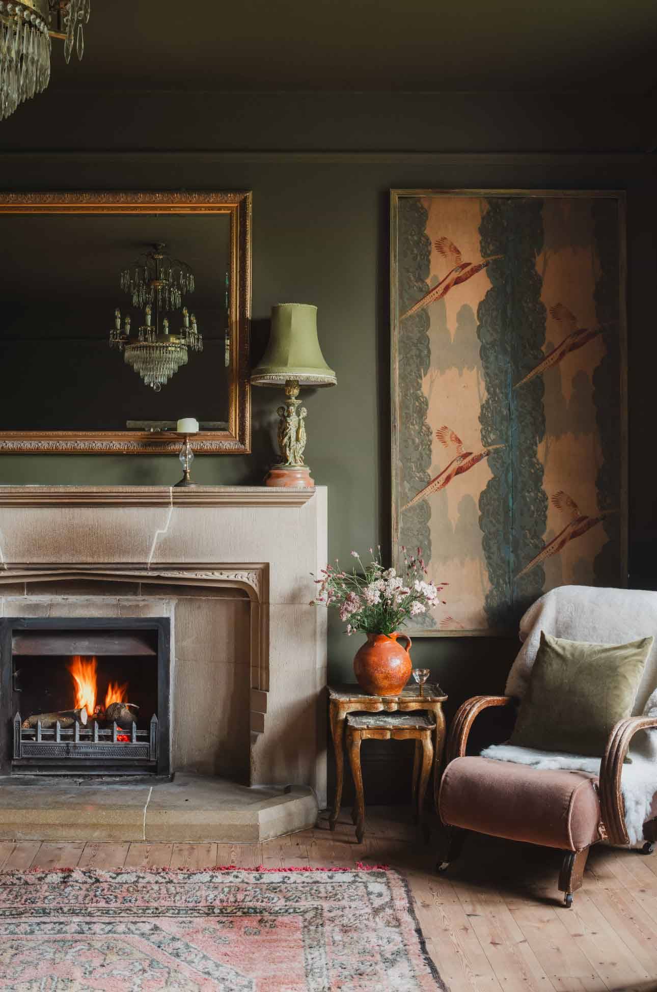 Classic stone fireplace hearth and floral artwork detail in a Grade II-listed Newquay location home via Love Locations.