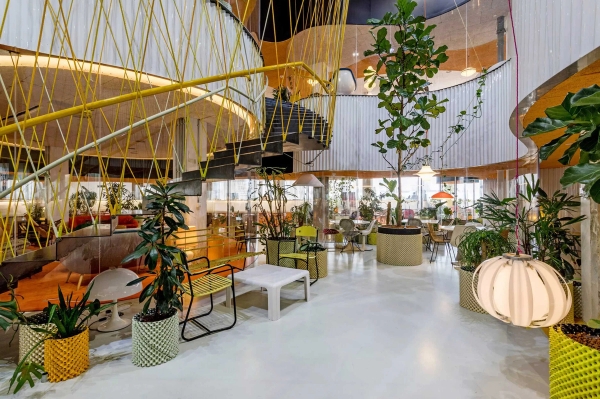 Modern glass-canopy café and social venue with colourful seating in Whitechapel London E1 – love locations