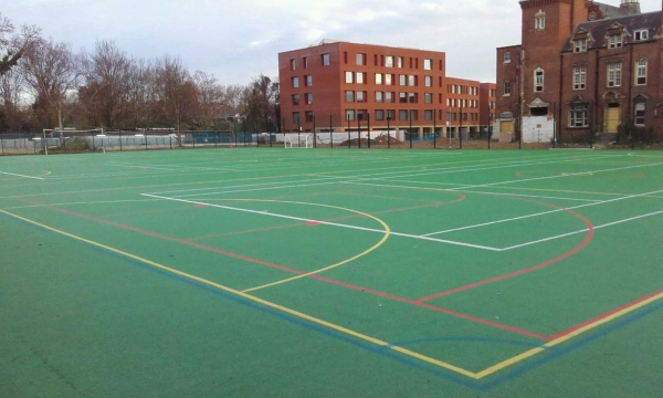 Outdoor green astro turf sports pitch and school playground location space in East Dulwich, SE22, via Love Locations.