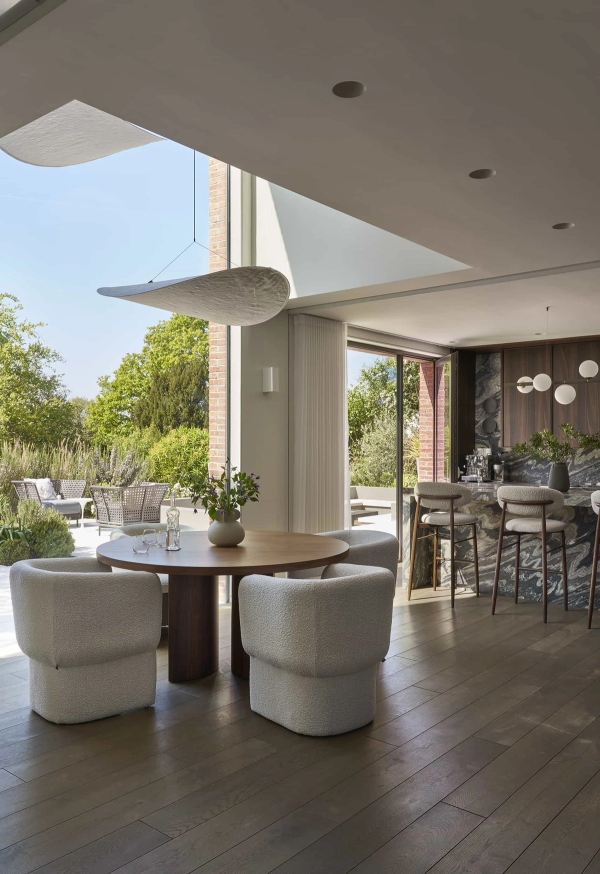 Open-plan architectural kitchen and dining space with floor-to-ceiling glass doors, a premium photography location by Love Locations.