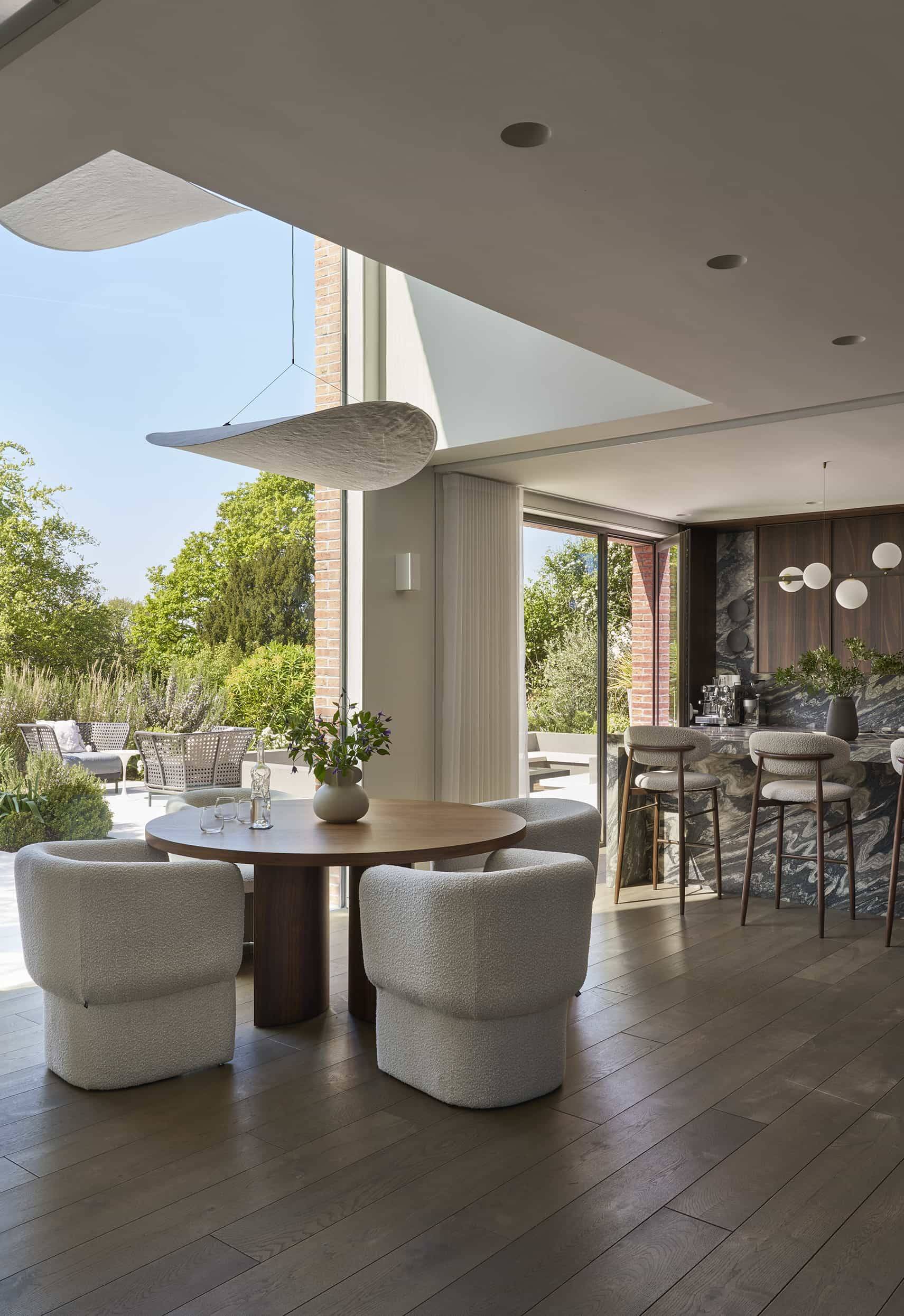 Open-plan architectural kitchen and dining space with floor-to-ceiling glass doors, a premium photography location by Love Locations.