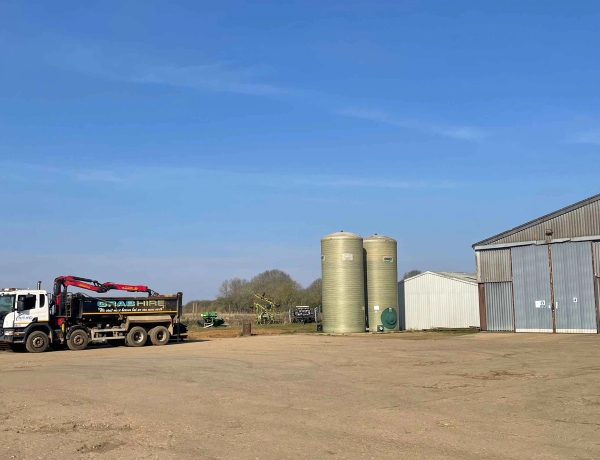 Wide farmyard and agricultural courtyard complex featuring modern sheds and outdoor working space, Love Locations.