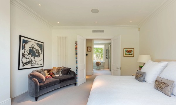 View looking through open double doors into a spacious master bedroom suite with neutral styling, perfect for home textile brand campaigns, Love Locations W4.