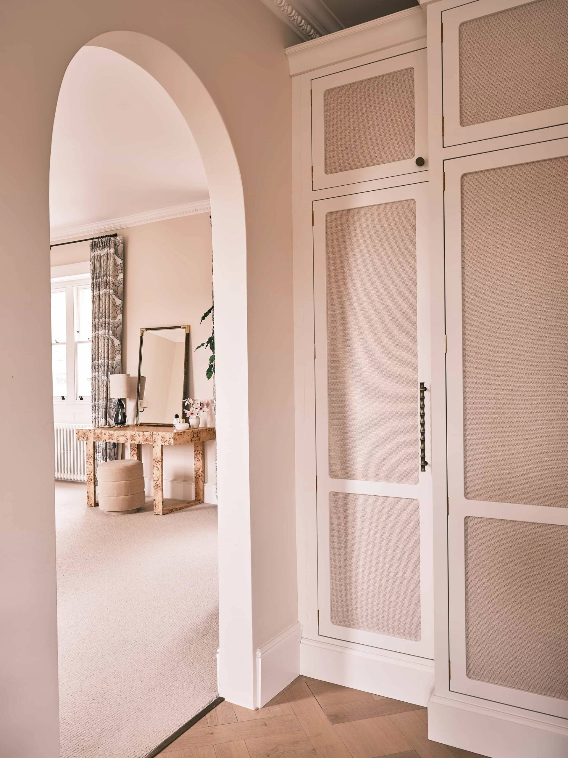 Blush pink bedroom doorway view leading into a marble ensuite bathroom in Shipton Under Wychwood, Love Locations.