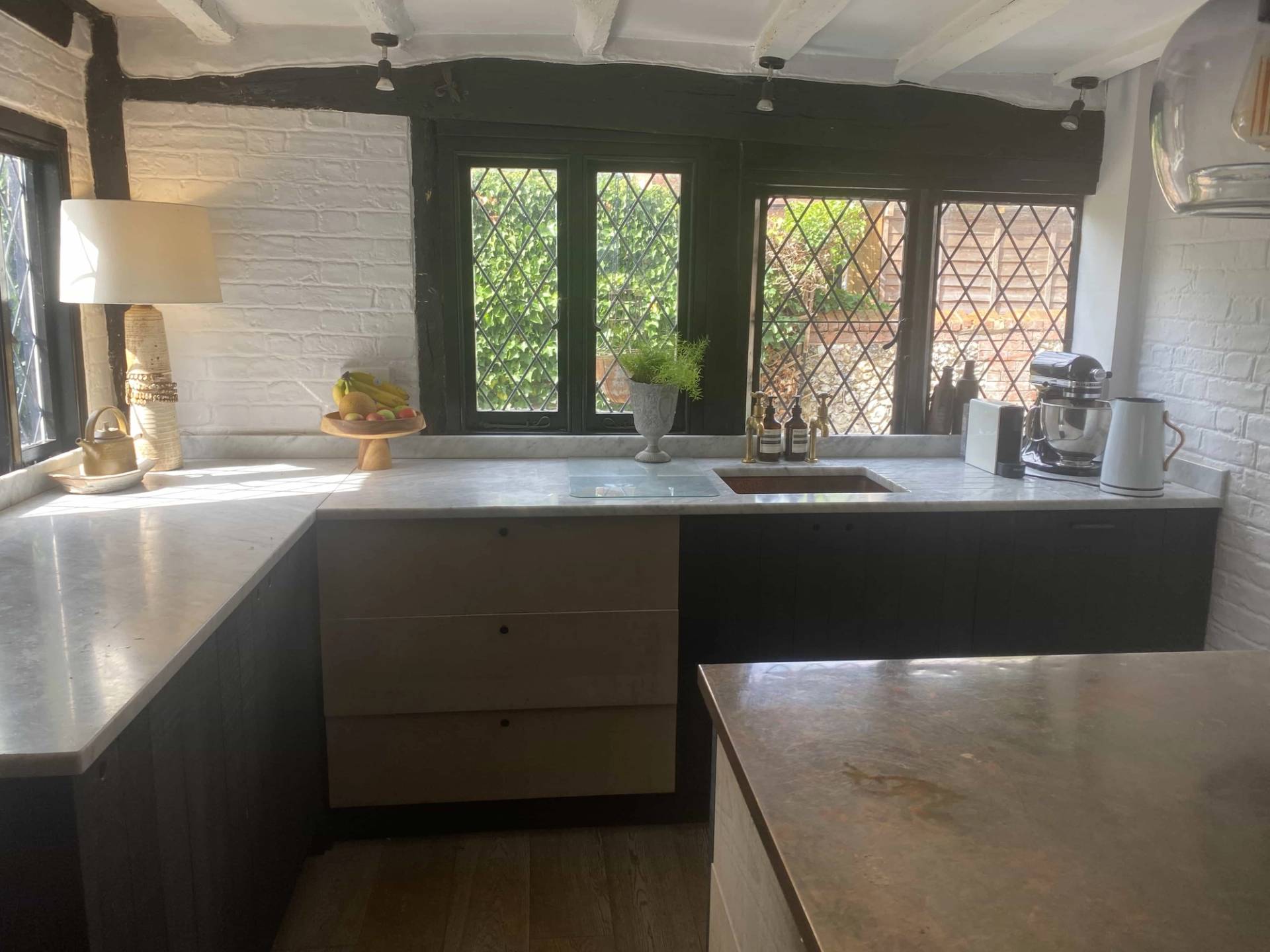 Queen Anne style window framing a bright cottage kitchen workspace with traditional leaded glass panes, perfect for period lifestyle lookbooks, Love Locations RG9 6QD.