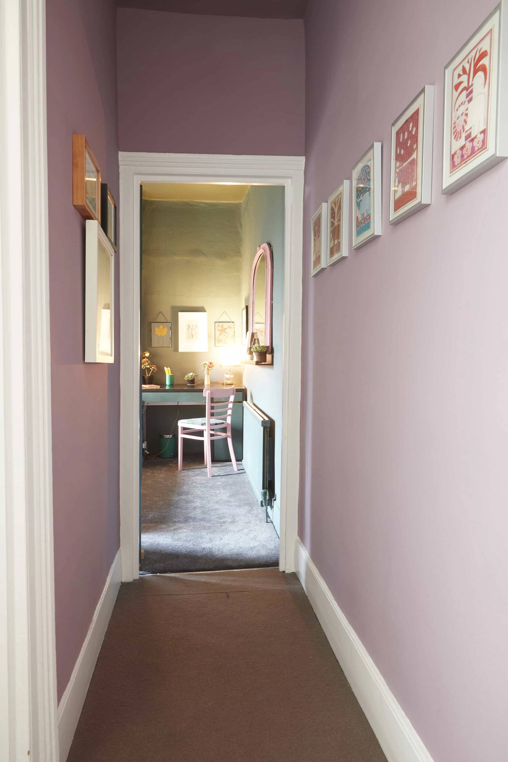 Lilac painted hallway transition looking through into a dark teal bedroom with pink chair, Love Locations N5.