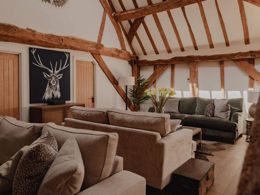 Mezzanine lounge overview looking past exposed timber cross-beams and stag art panels, perfect for atmospheric TV drama filming, Love Locations.