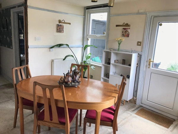 Sunlit wooden dining table vignette with vintage details and indoor house plants, perfect for authentic domestic brand campaigns, Love Locations SE25.