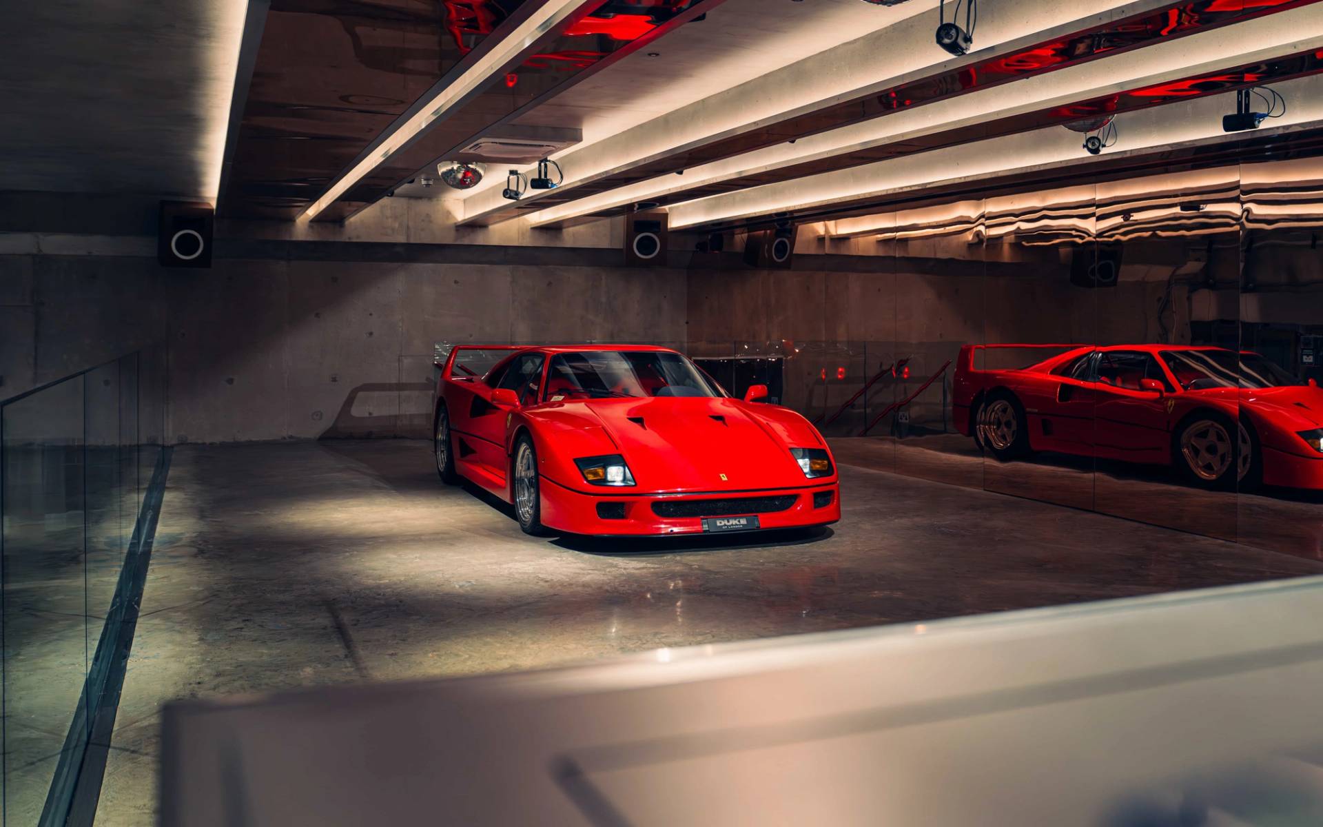 Dramatic spotlighting on a classic red Ferrari F40 in a polished concrete shoot location in Brentford TW8 through Love Locations.