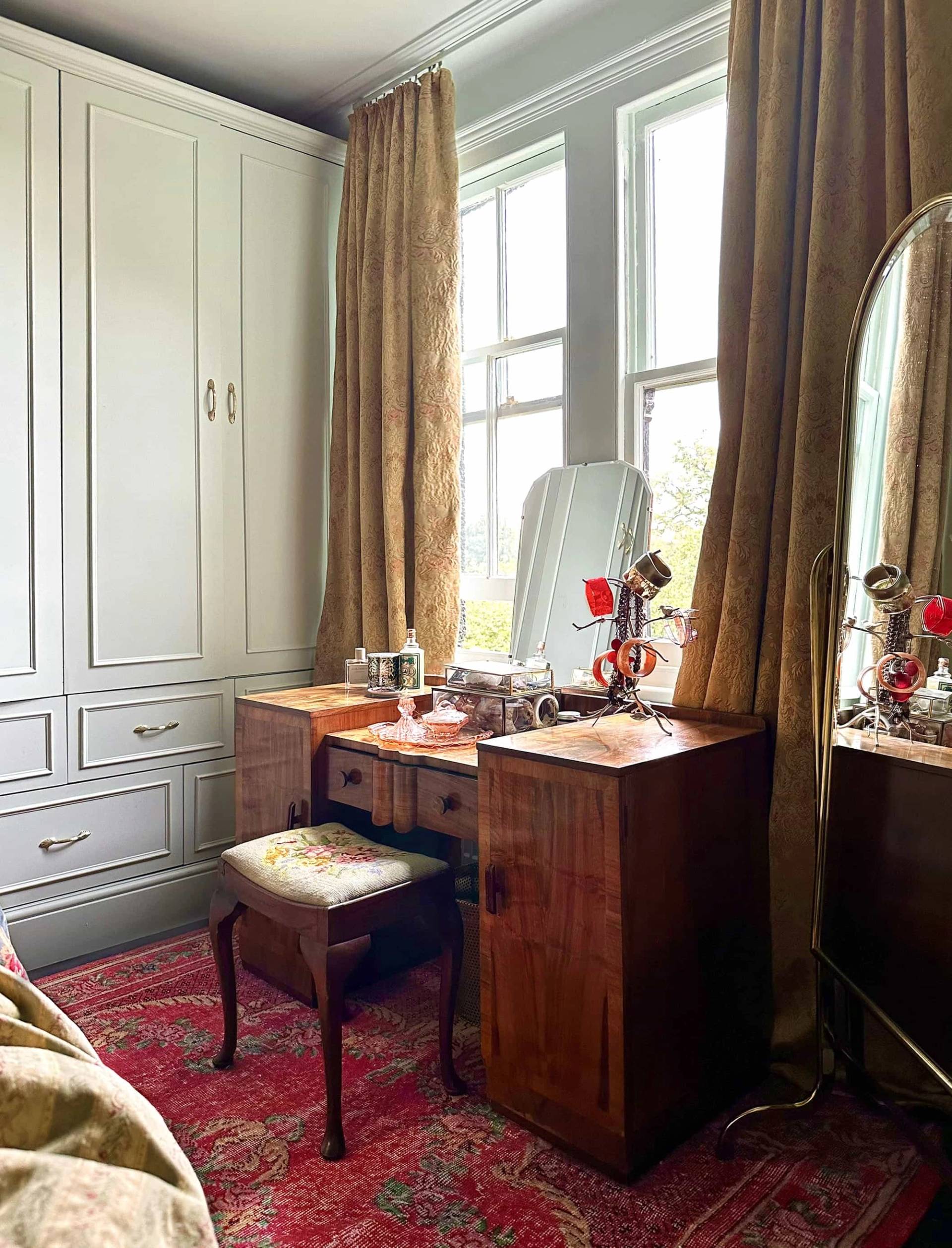 Vintage dressing table with wooden mirror set in a bright bedroom bay window nook, Love Locations N13.
