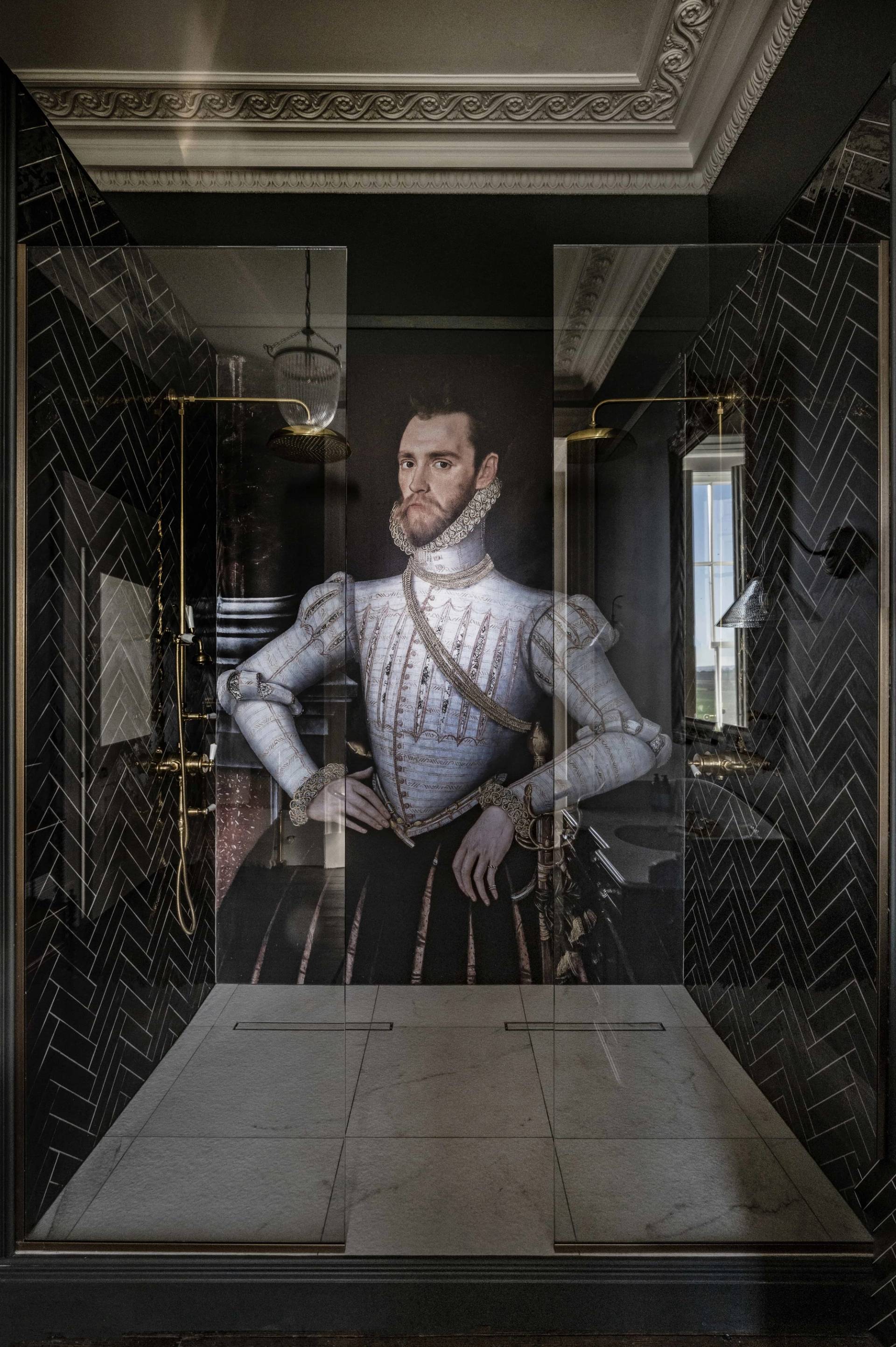 Dramatic dark bathroom enclosure featuring a statement Elizabethan mural glass shower screen, perfect for luxury brand campaigns via Love Locations.