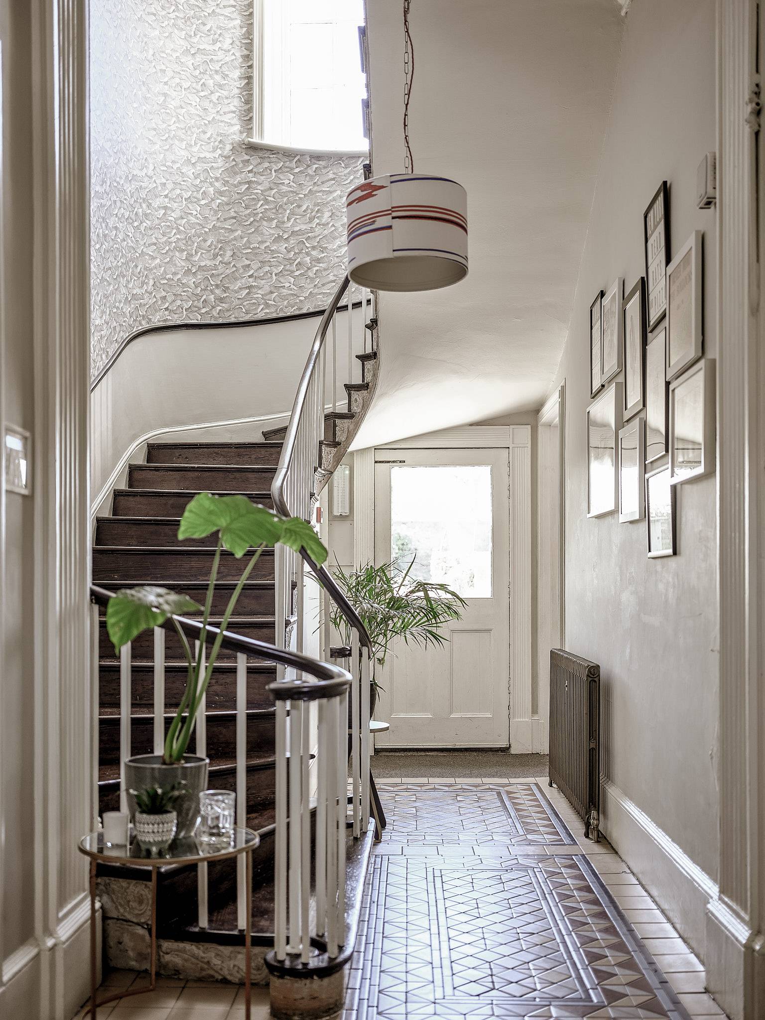 Curved Georgian spiral staircase with black iron banisters, decorative tile flooring, and white sash window, ideal for period drama scenes, Love Locations ME13.