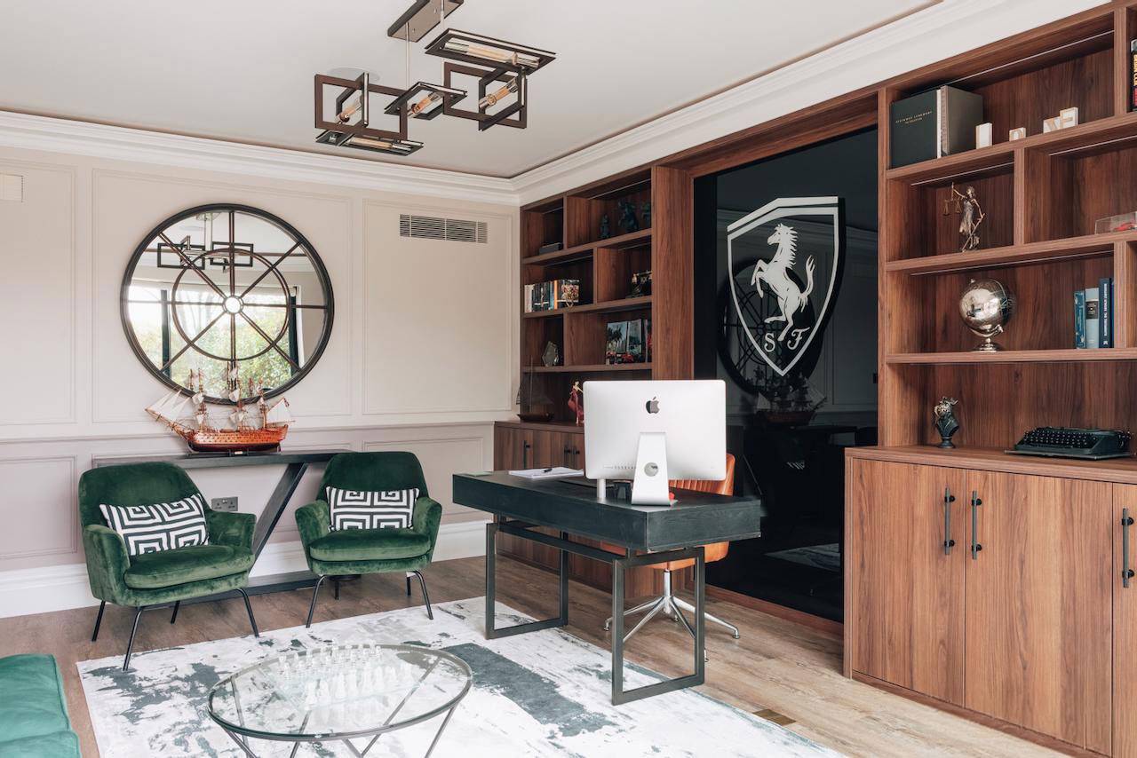 Luxury study room with a Ferrari shield wall feature, green velvet armchairs, and dark timber desk, Love Locations W5.