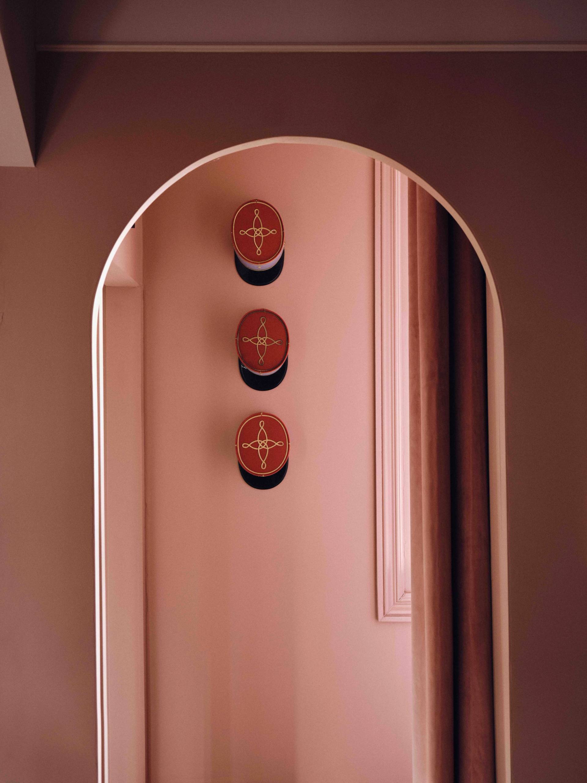 Wall nook feature set with three decorative ceramic plates framed by a plaster arch, Love Locations CR0.