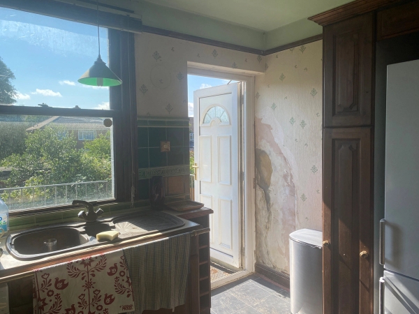 Unprocessed kitchen back door space showing naturally distressed walls and raw character textures, ideal for low-budget film productions, Love Locations SE25.
