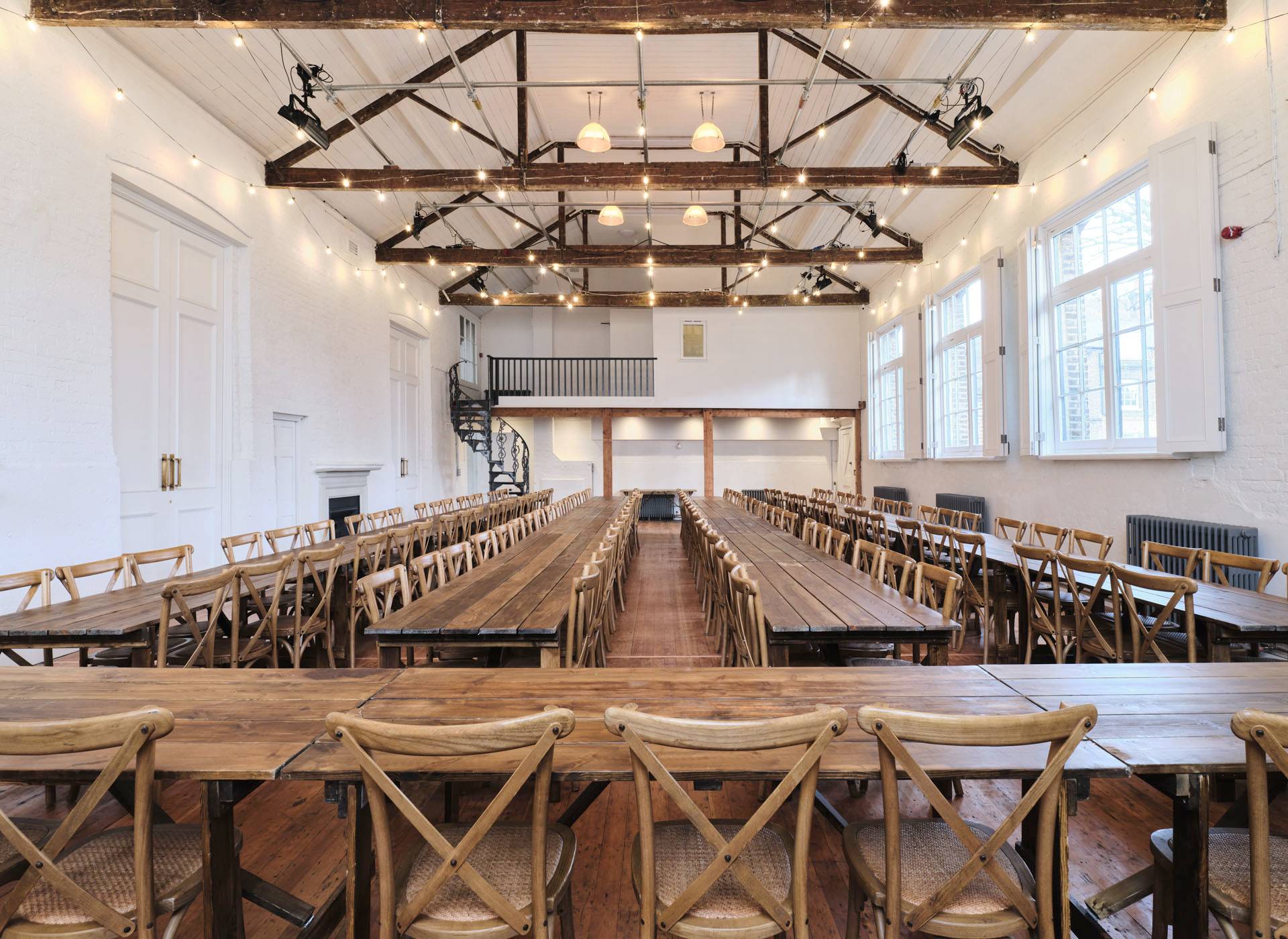 Banquet event hall configuration with long dining tables set under exposed timber roof trusses, perfect for luxury brand launches, Love Locations E2.