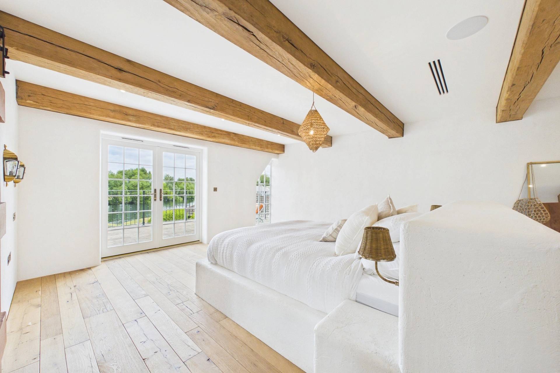 Love Locations luxury bedroom with exposed beams and wooden floors for shoots