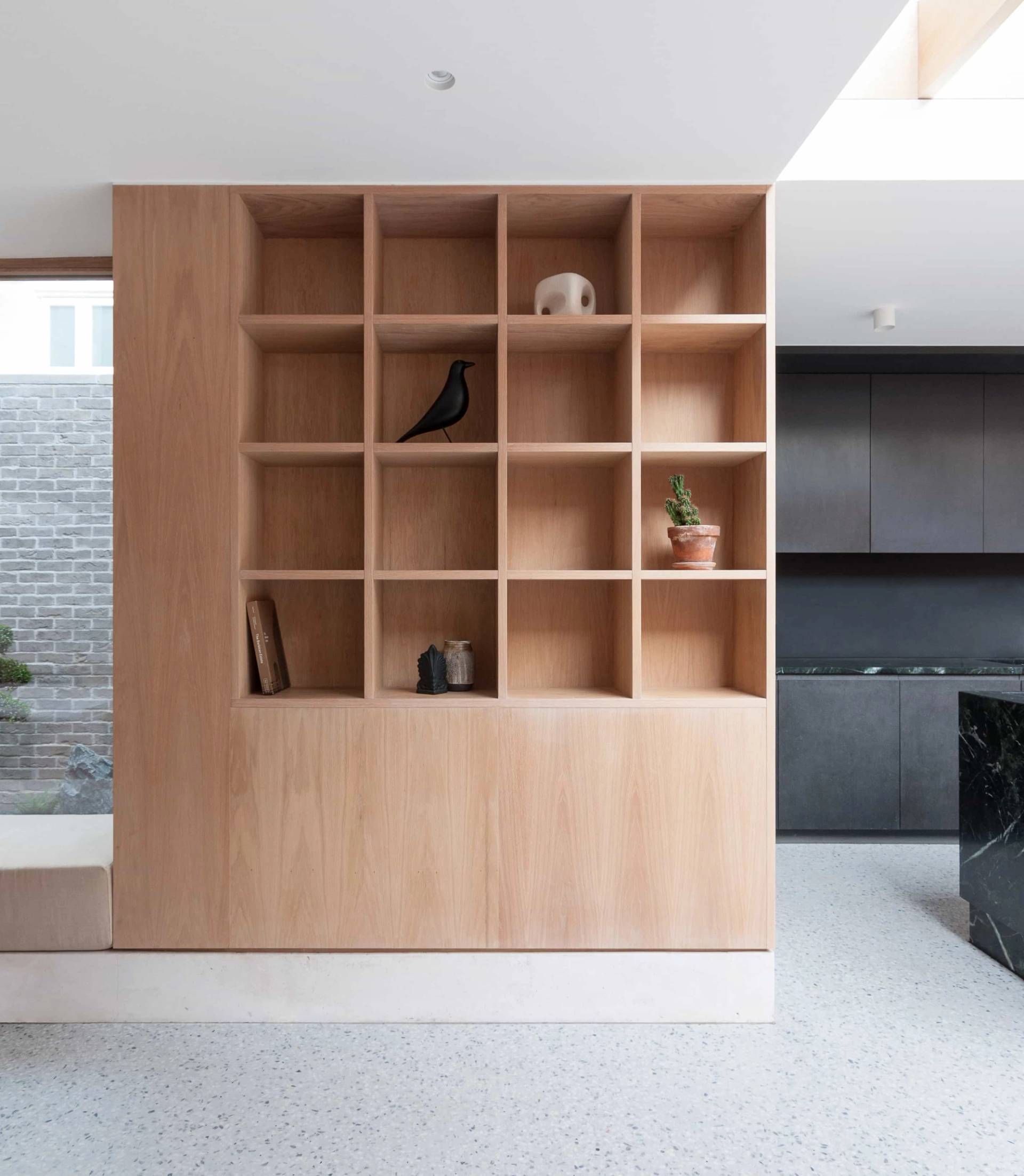 Open grid bookshelf joinery feature in a modern location house in Hackney N16 from Love Locations, showcasing bespoke light wood shelving.