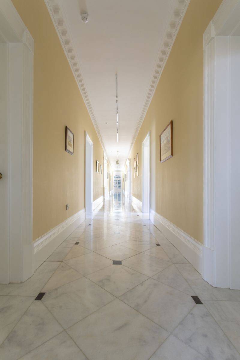 Grand formal hallway with polished marble flooring and classic arches, a premium shoot location in Haywards Heath, RH17 by Love Locations.