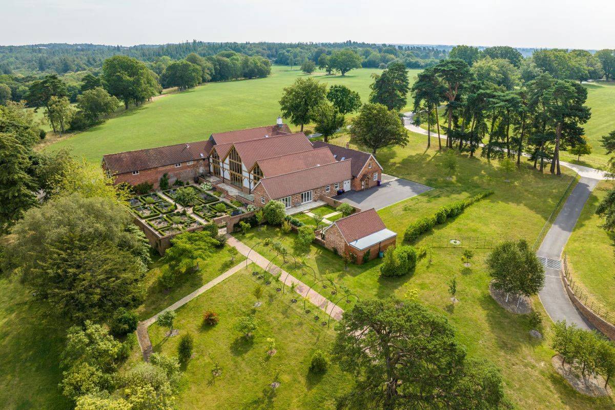 Bird's-eye view of the full Greentrees barn event venue, courtyard, and formal landscaping, premium venue hire via Love Locations.