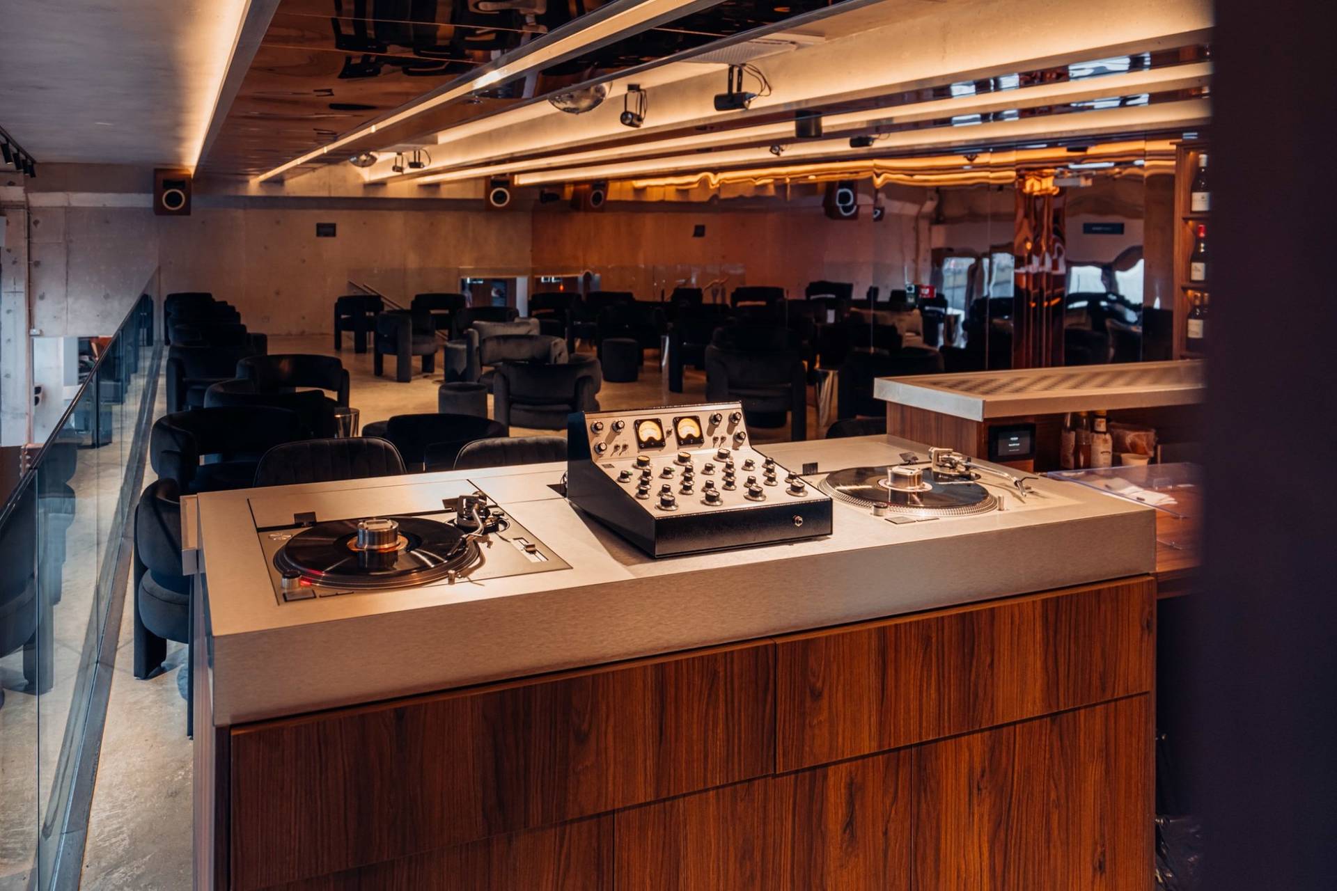 Professional DJ booth and rotary mixer station inside a modern audiophile listening bar location house through Love Locations.