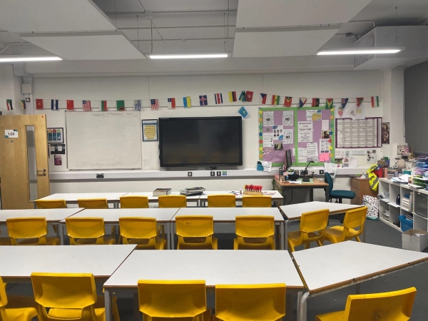 Love Locations primary school location Reading: Traditional rowed classroom setup with yellow chairs and interactive whiteboard, tailored for educational videos and TV series.