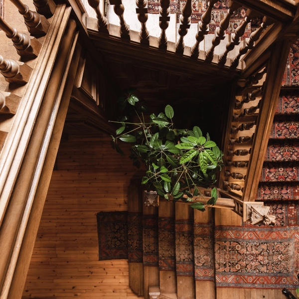 Carved dark wood spiral staircase detail in a historic Scottish castle interior, Love Locations KY15.