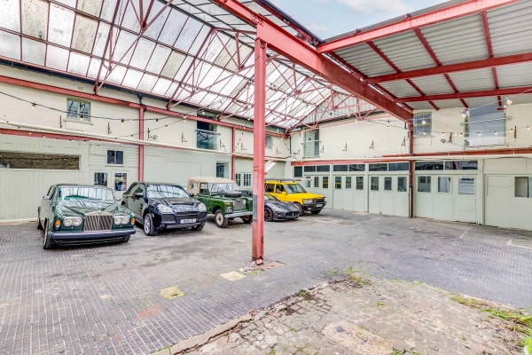 Industrial courtyard location space with vintage and classic cars parked for automotive editorial shoots, Love Locations.