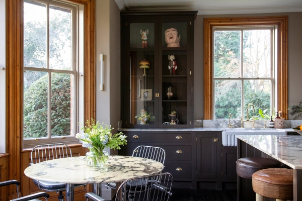 Kitchen breakfast nook featuring a round dining table, dark wood dressers, and sash window light, Love Locations ME13.