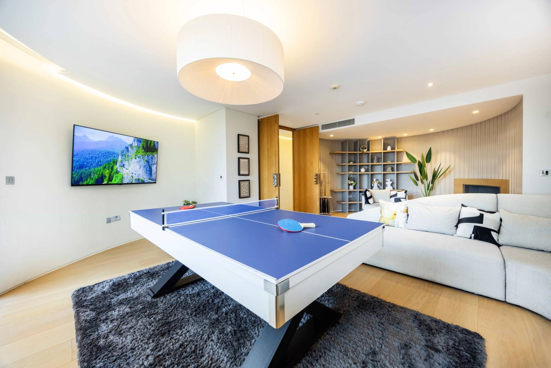 Games room transition view showcasing a blue table tennis conversion top set on a white pool table, Love Locations WD7.