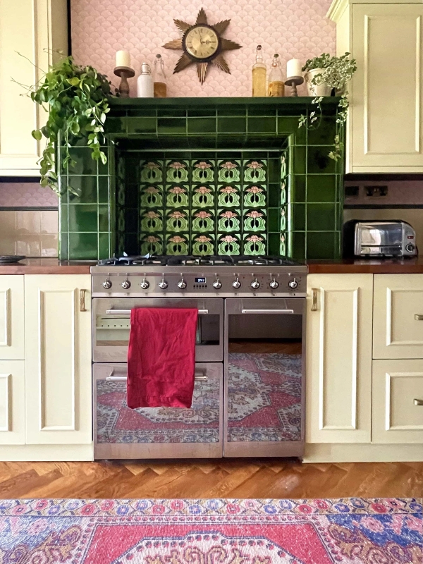 Silver Range cooker flanked by cream kitchen units and vibrant green tiled splashback for culinary shoots, Love Locations N13.