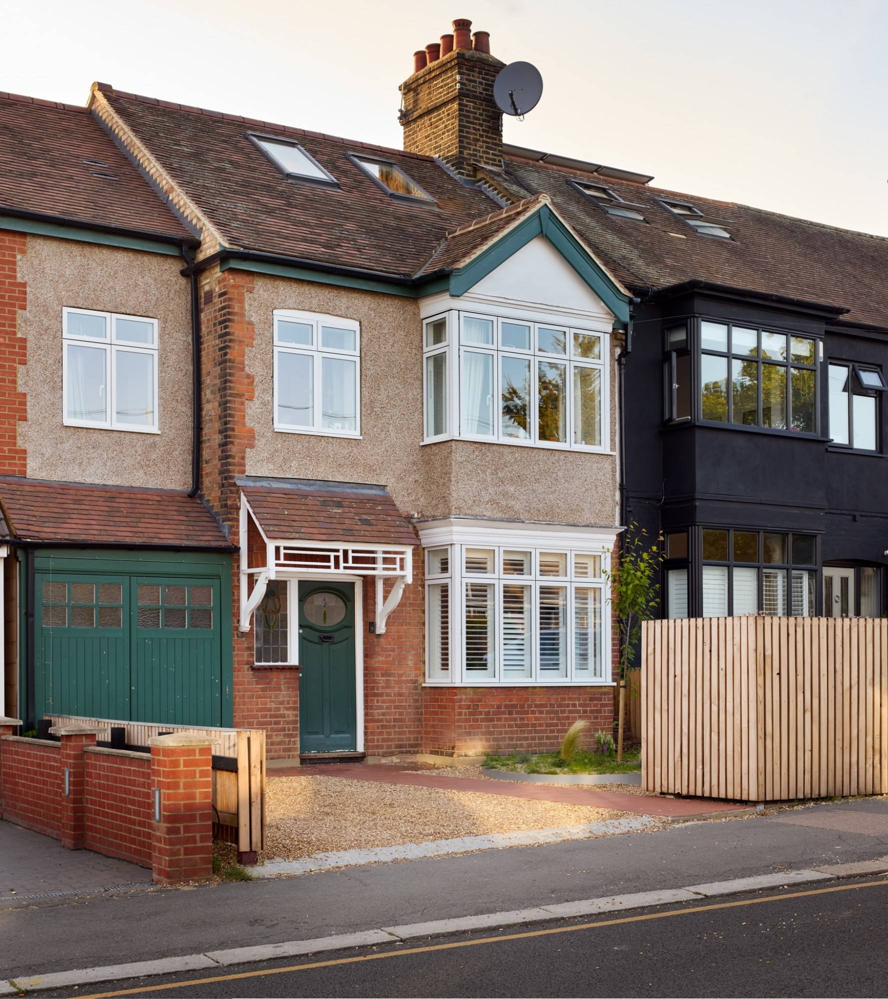 Front facade view of a remodelled double-fronted 1930s semi-detached house with timber slatted fence and driveway in Walthamstow, Love Locations E17.