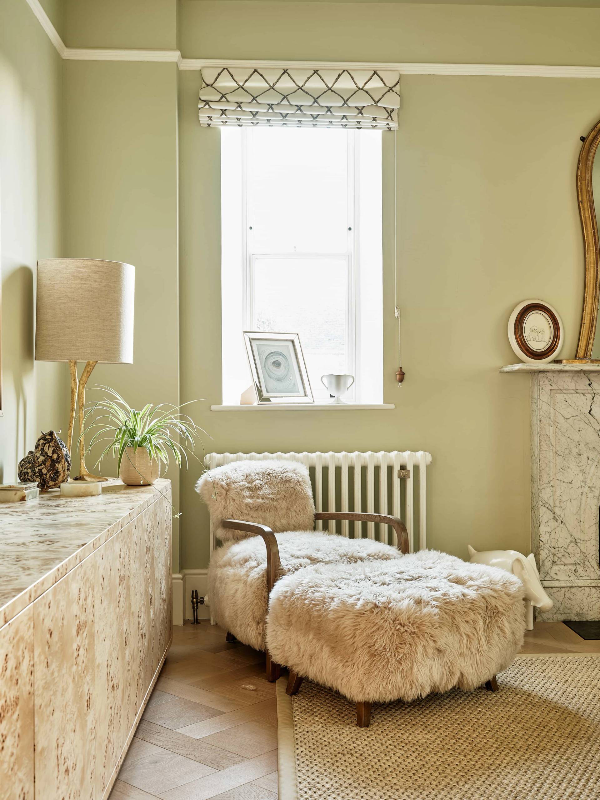Lounge nook with a fluffy bouclé lounge chair set beside a sash window and marble fireplace mantelpiece, Love Locations OX7.
