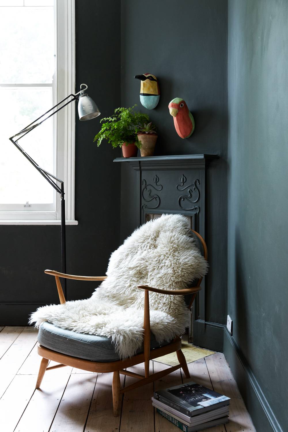 Atmospheric study room with dark teal walls, cast iron fireplace, and vintage armchair with sheepskin throw, ideal for drama filming, Love Locations N13.