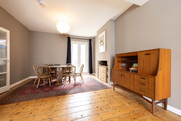 Love Locations characterful open plan home Forest Gate: Wide angle view across a warm dining space showing authentic stripped pine floorboards, great for tracking shots and lifestyle catalog shoots.