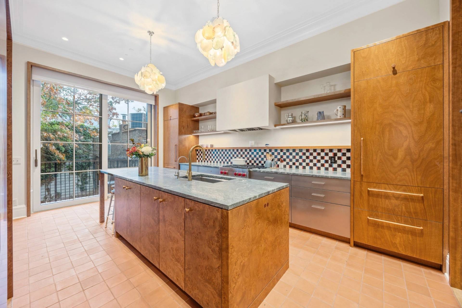 Contemporary open-plan kitchen shoot space in Boerum Hill Brooklyn NY 11217 via Love Locations, showcasing a rich wood island, stainless steel counters, checkered backsplash tile, and high ceilings.