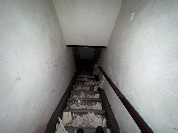 Steep, narrow wooden staircase with peeling paint and rustic handrails in an abandoned Nottinghamshire cottage, Love Locations.