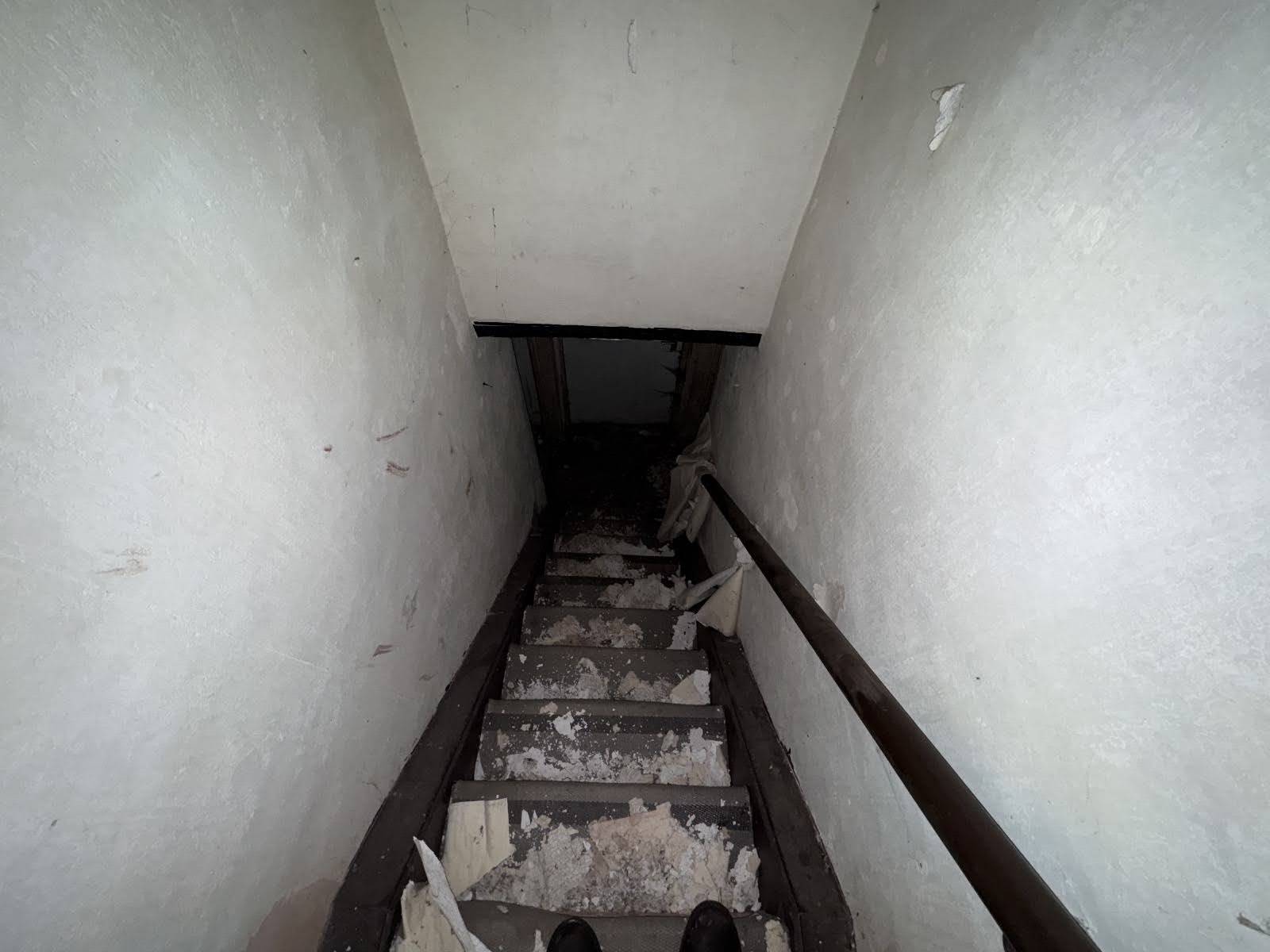 Steep, narrow wooden staircase with peeling paint and rustic handrails in an abandoned Nottinghamshire cottage, Love Locations.