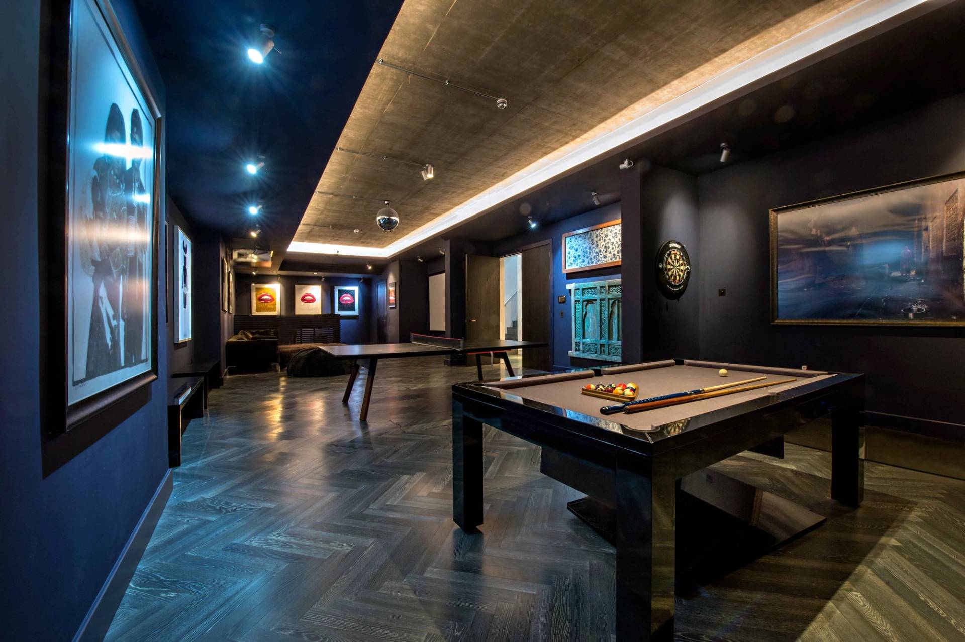Atmospheric basement games and entertainment room featuring a professional pool table, mood lighting, and dark color palettes, Love Locations NW3.
