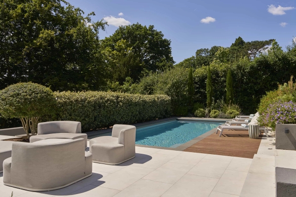 Sun-drenched outdoor pool location with luxury wood-decked sun loungers, ideal for commercial hire via Love Locations.